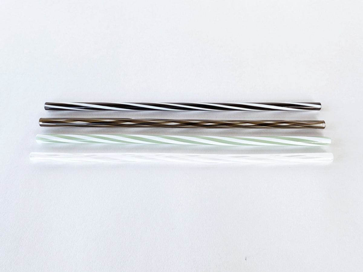 Twisted glass straws in a glass