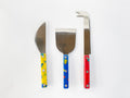 Red, yellow, and blue three-piece cheese knife set