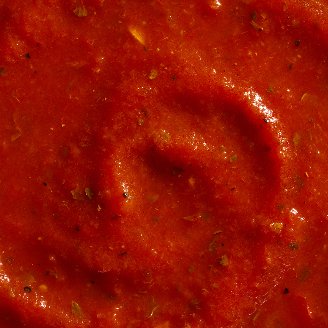 Close-up of the marinara showing visible herbs