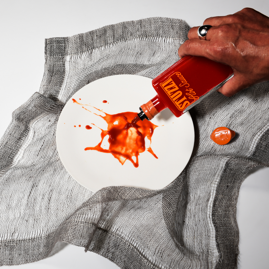 Stuzzi hot sauce styled on a table